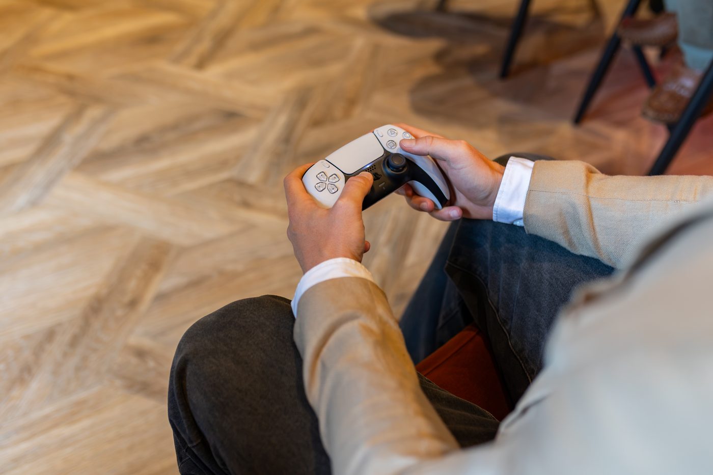 A PlayStation controller in hand in the bar at Warren House
