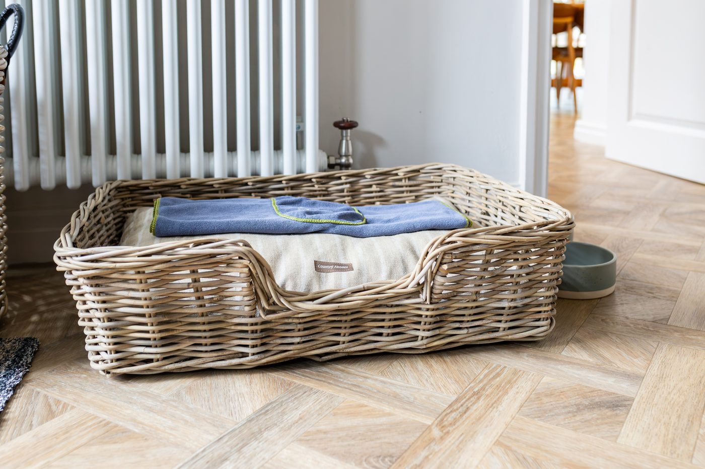 The dog bed, bowls and basket waiting in the boot room at Warren House