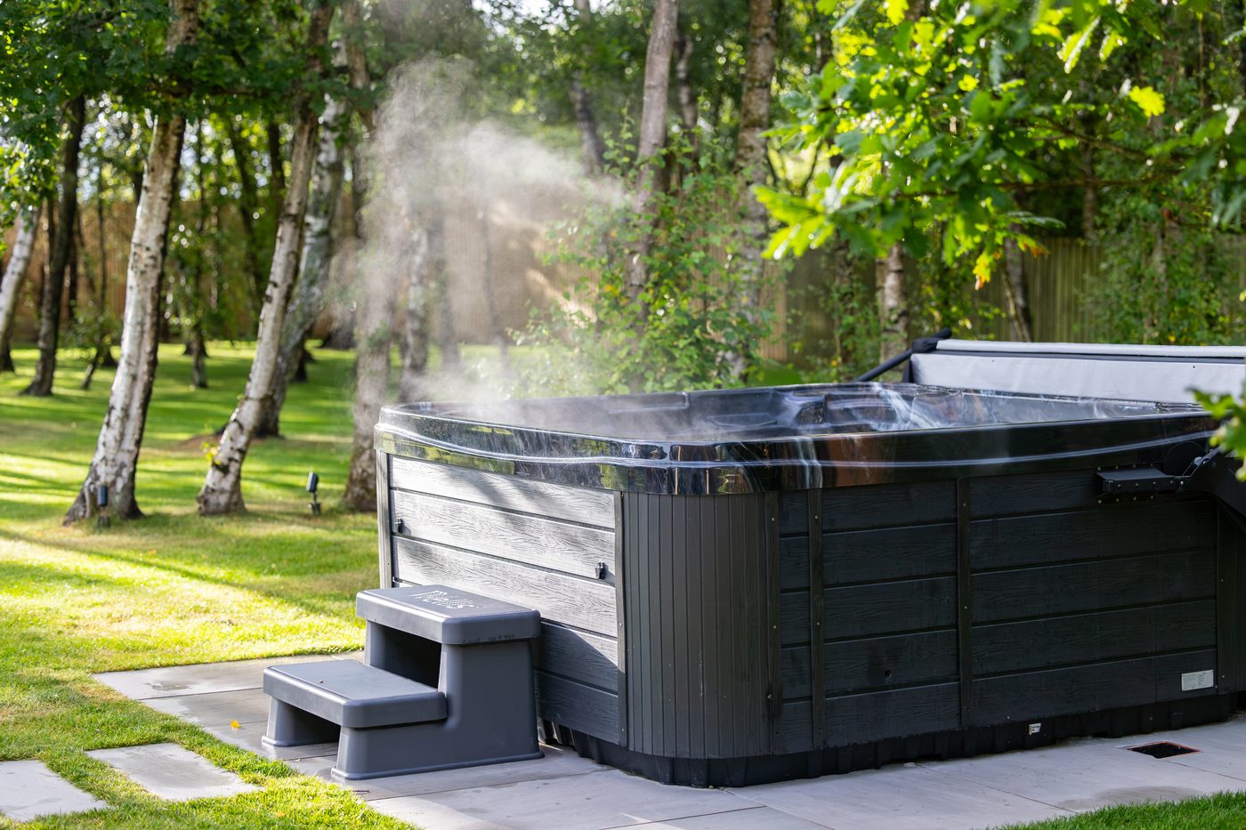 The hot tub steaming among the silver birches at Warren House