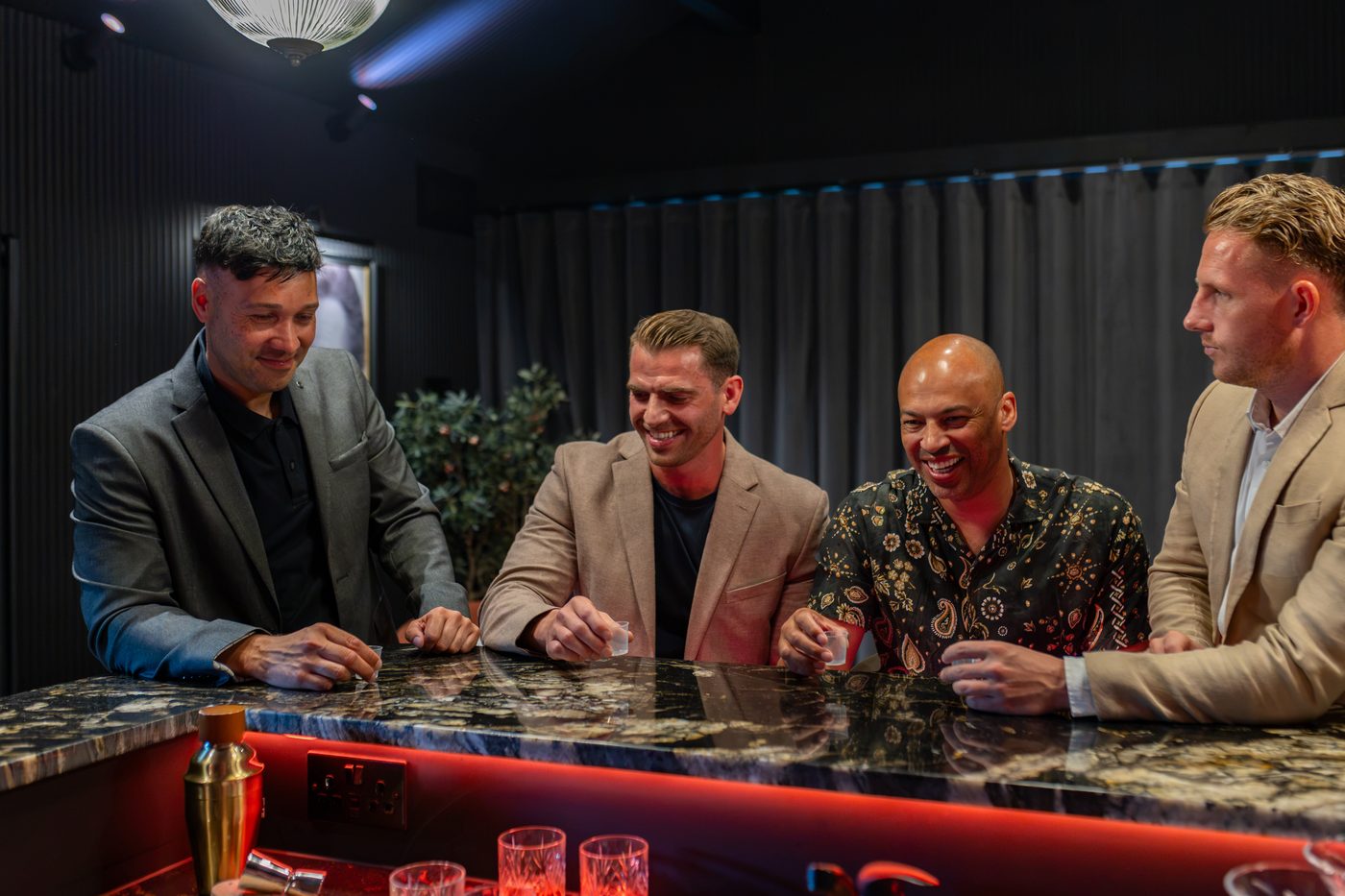 Friends taking on a round of drinking games at the bar at Warren House