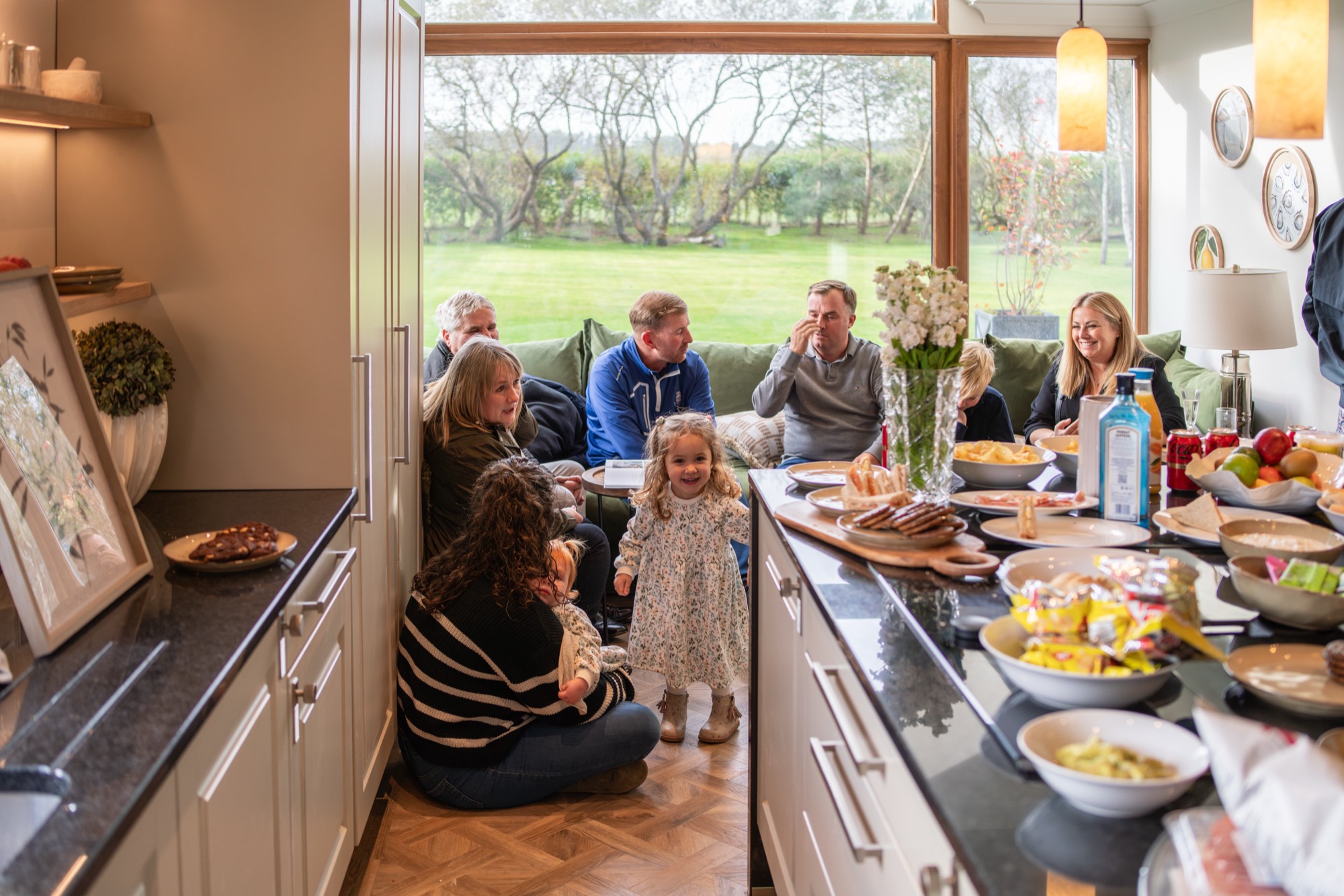 A family gathered together in the kitchen at Warren House